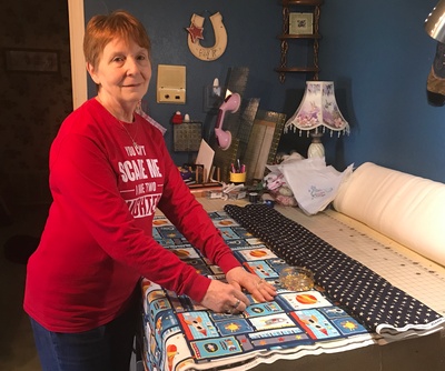 Nancy pinning a quilt